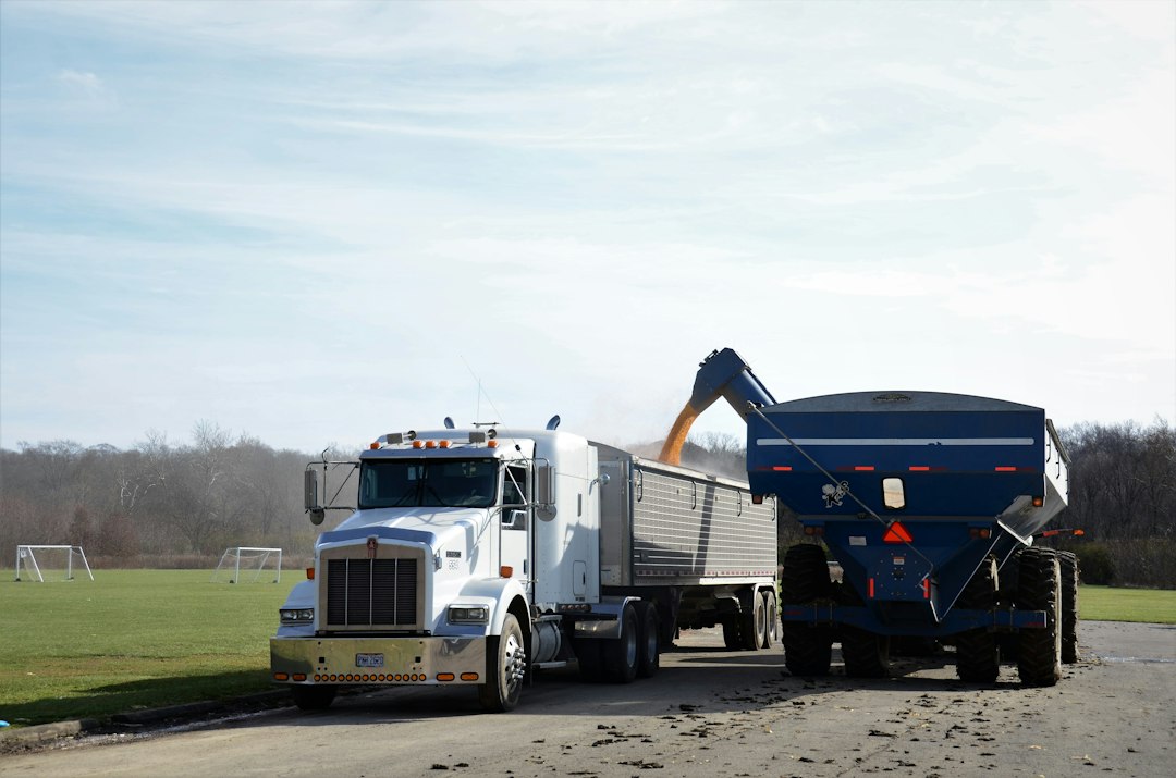 Commercial grain trailer being loaded for hauling, illustrative stock photo